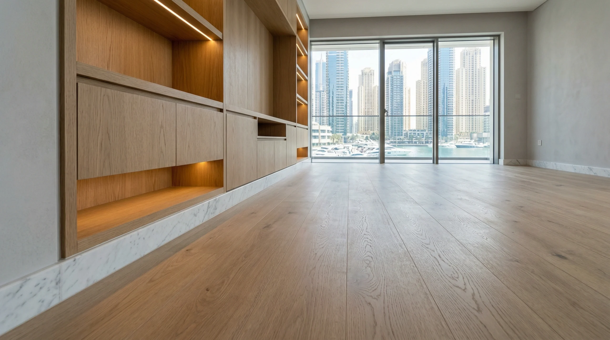 Wide-plank light oak SPC flooring installed in a modern Dubai apartment.