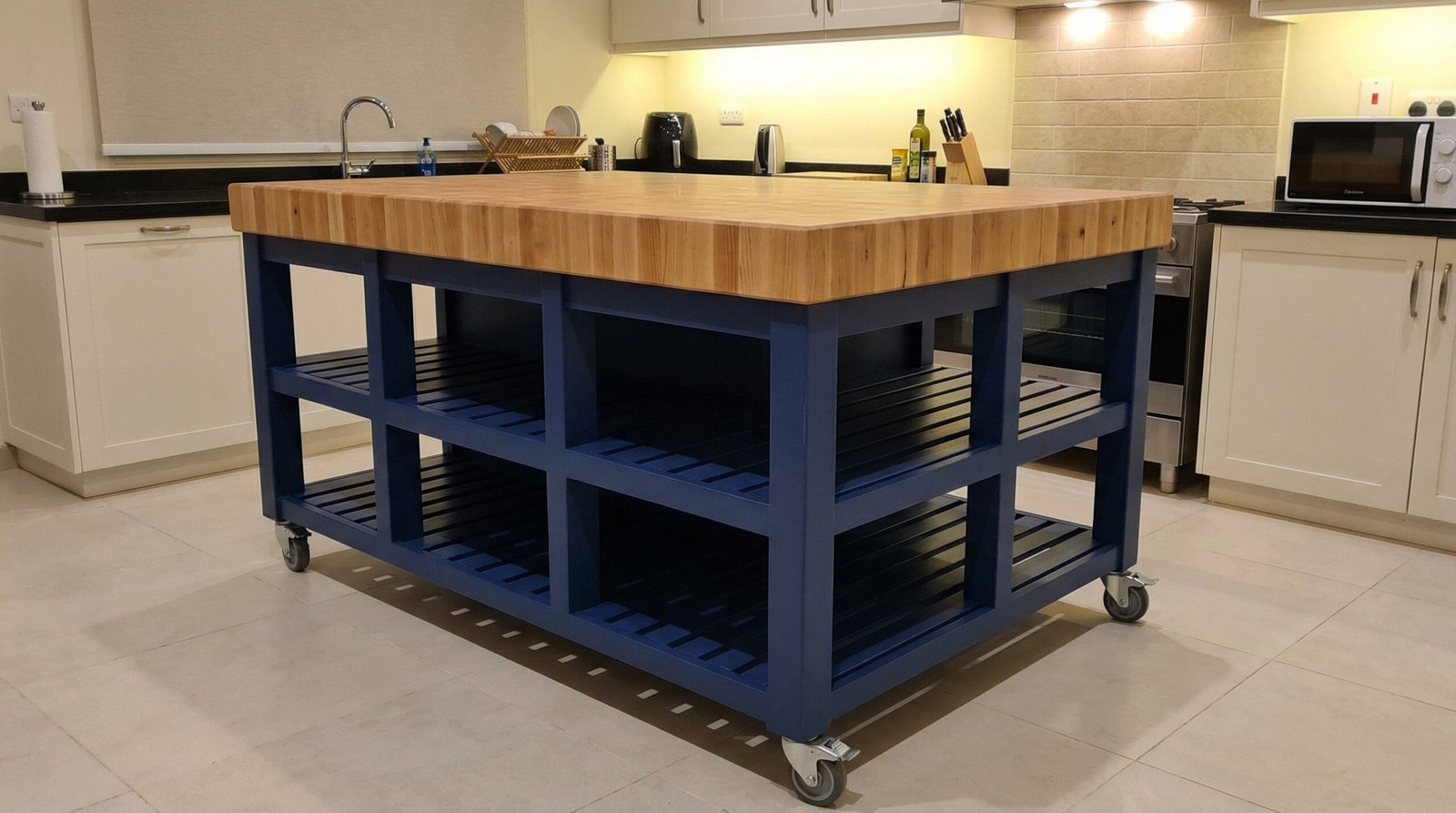 Versatile custom-built mobile kitchen island with a thick end-grain butcher block top and heavy-duty casters, Mirdif home.