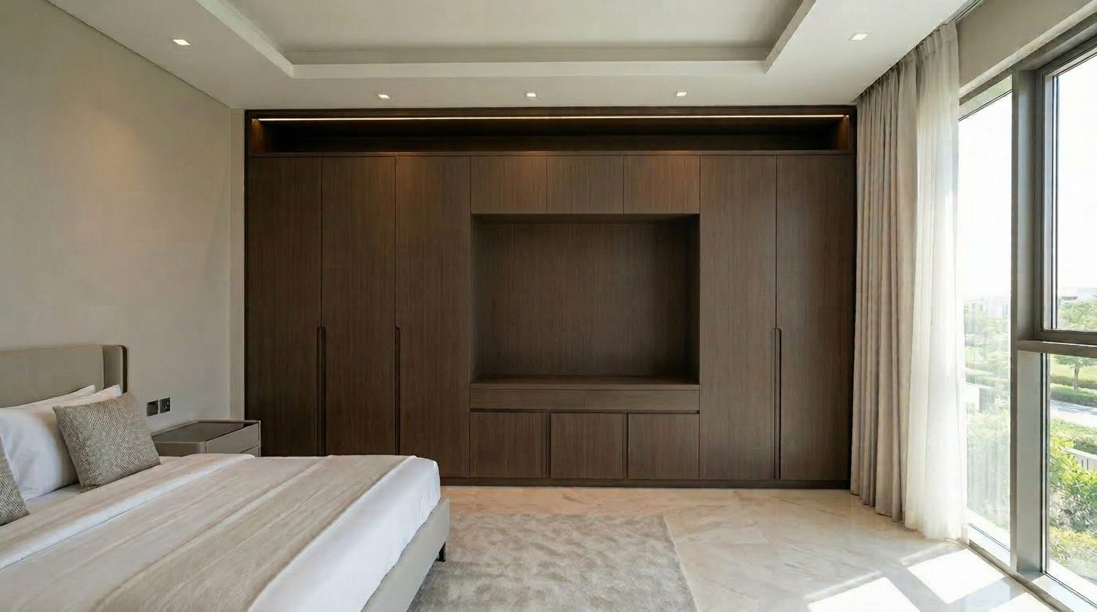 Completed built-in wardrobe with LED pelmet lighting and Karnak handover folder at client walkthrough stage in Dubai Hills villa