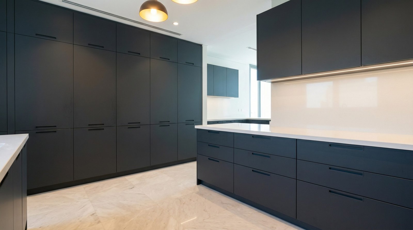 Floor-to-ceiling custom pantry and drawer kitchen cabinet storage system in charcoal finish installed in UAE family kitchen
