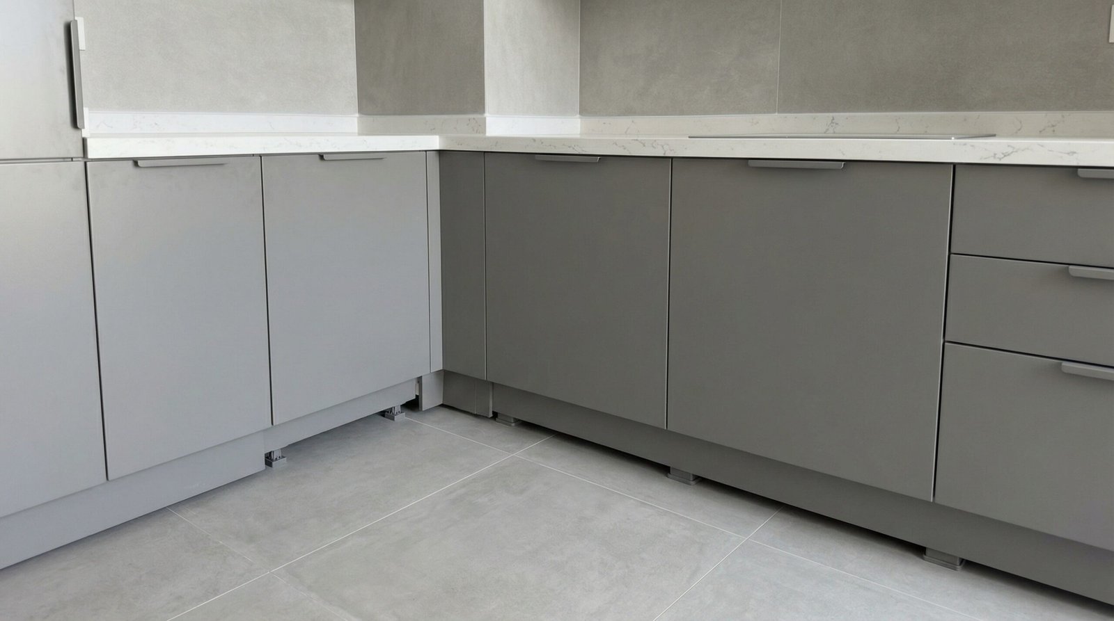 Climate-engineered grey matte kitchen cabinets with sealed moisture-protected base plinth installed in Dubai apartment