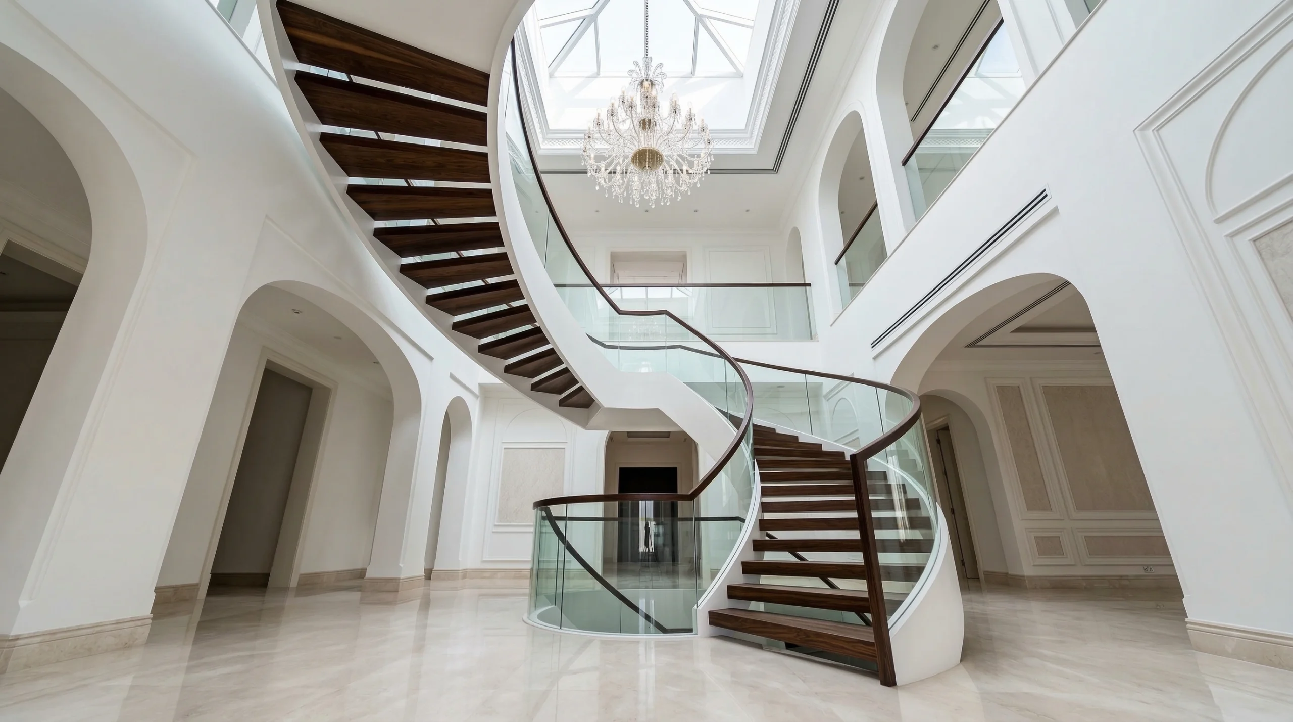Custom curved staircase with glass railings Dubai villa by Karnak Carpentry
