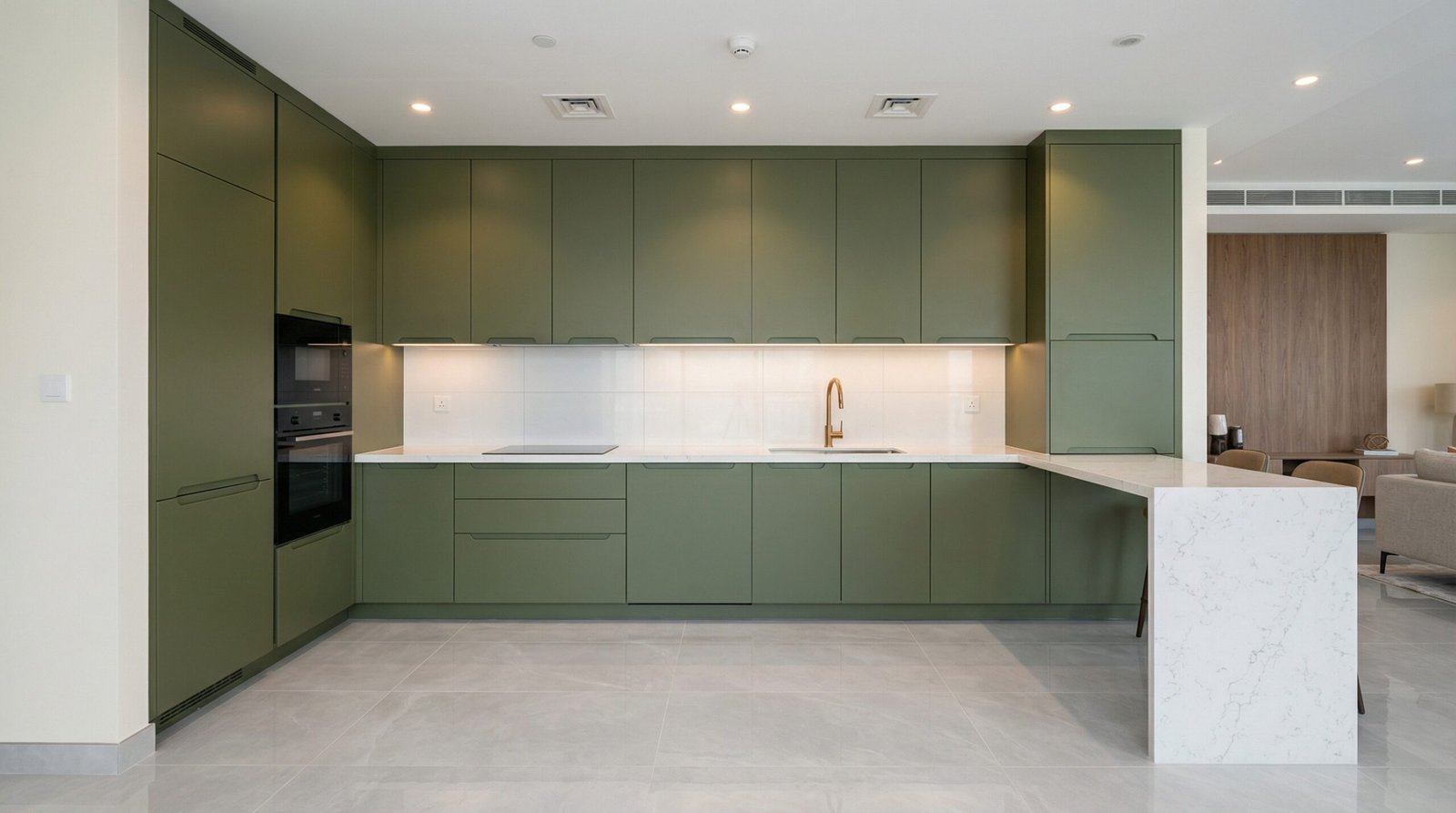 Floor-to-ceiling matte olive green kitchen cabinets with white quartz waterfall countertop in UAE apartment