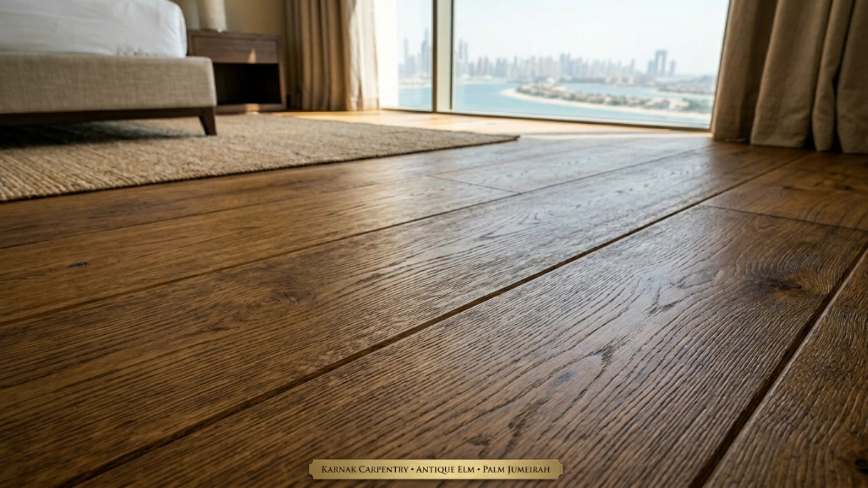 Detailed view of micro-bevel edges on antique elm wooden flooring planks installed in a Palm Jumeirah bedroom by Karnak Carpentry.