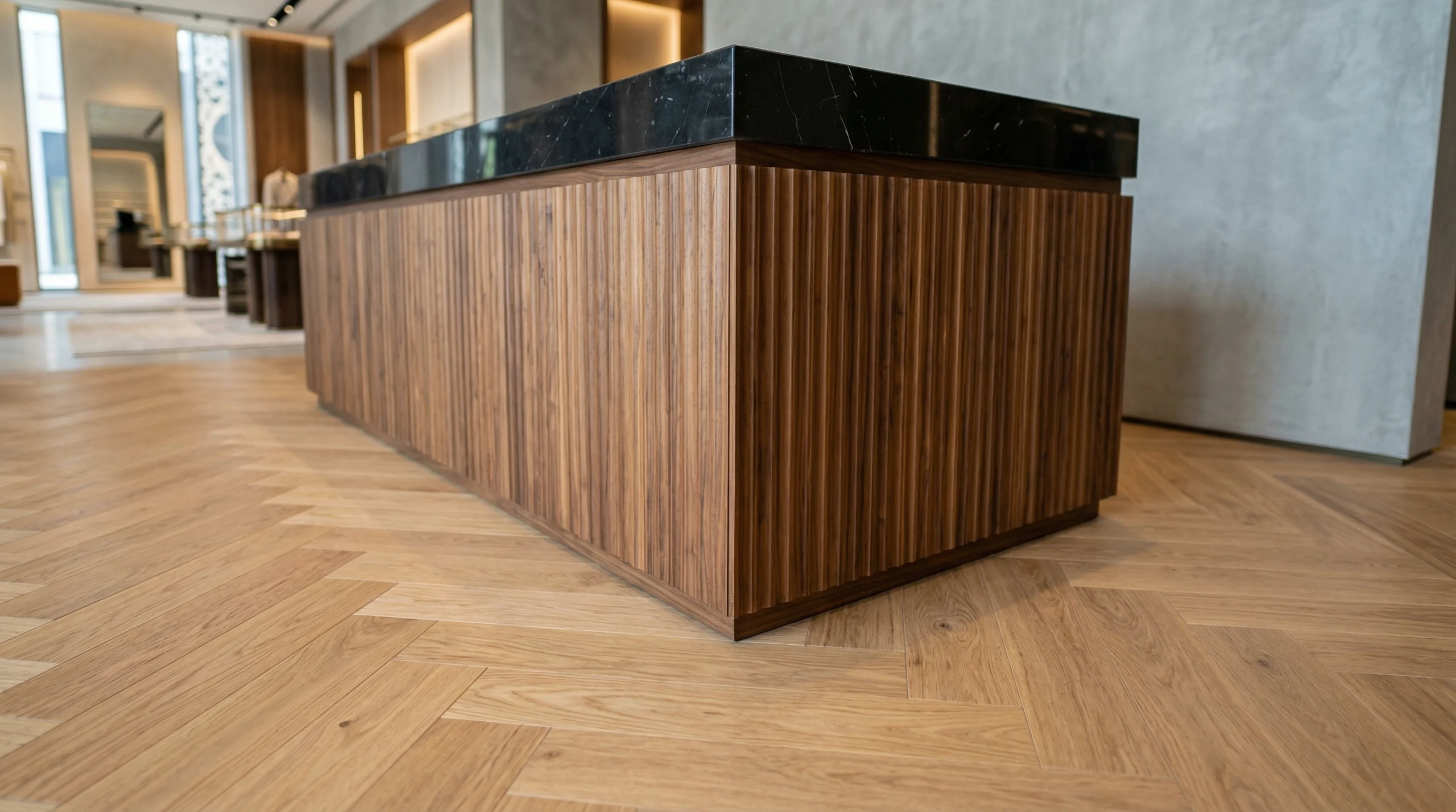 Herringbone oak SPC flooring in a boutique with a walnut counter.