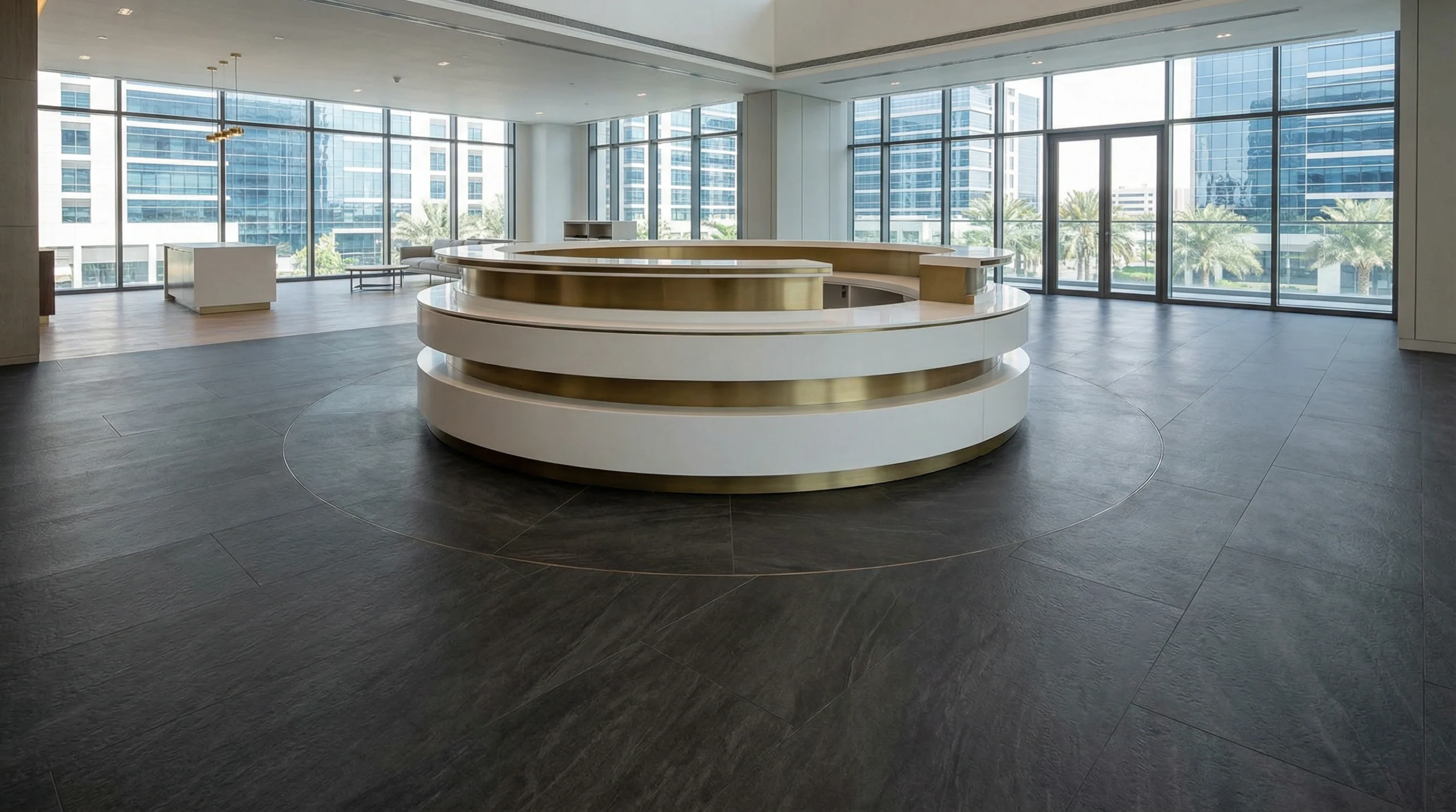 Dark charcoal SPC flooring installed around a custom curved reception desk.
