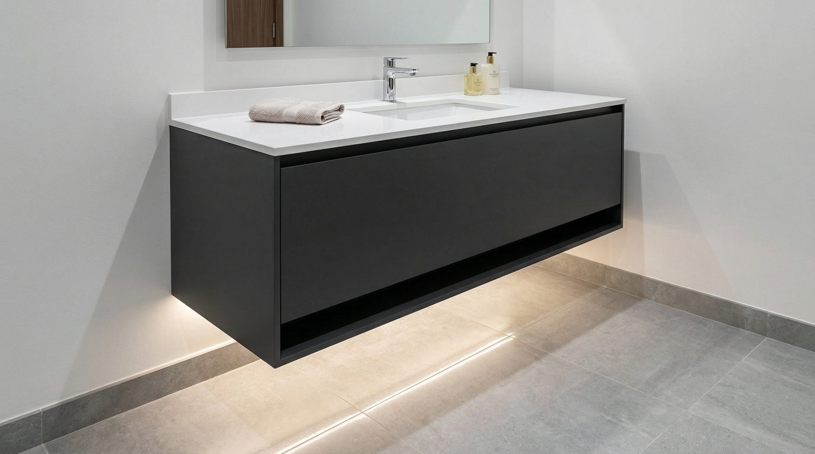 Matte charcoal floating wall-mounted bathroom vanity with LED shadow gap lighting installed in UAE apartment bathroom