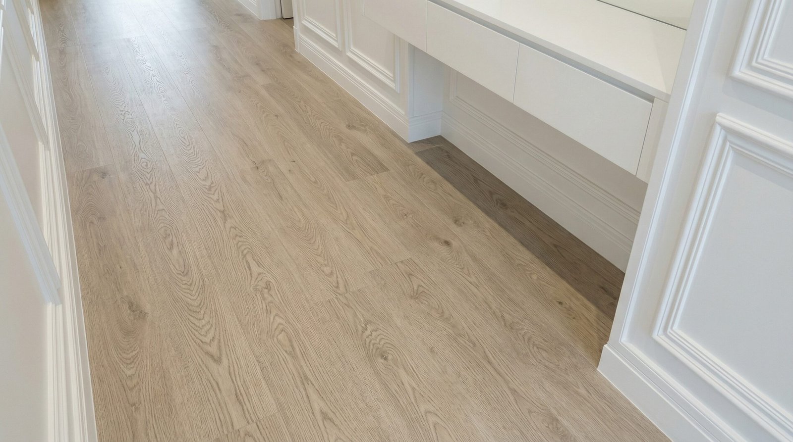 Light ash oak LVT flooring with realistic wood grain texture installed in a Jumeirah villa by Karnak Carpentry.