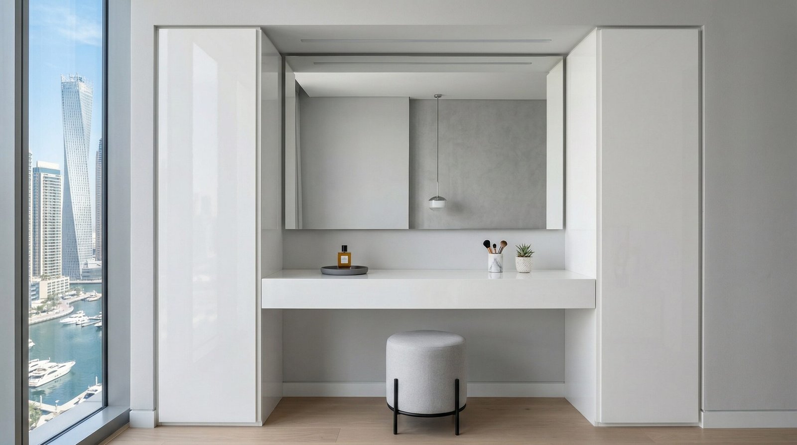 Contemporary minimalist built-in dressing table in high-gloss white lacquer with frameless mirror and push-to-open cabinets installed in Dubai Marina by Karnak Carpentry UAE