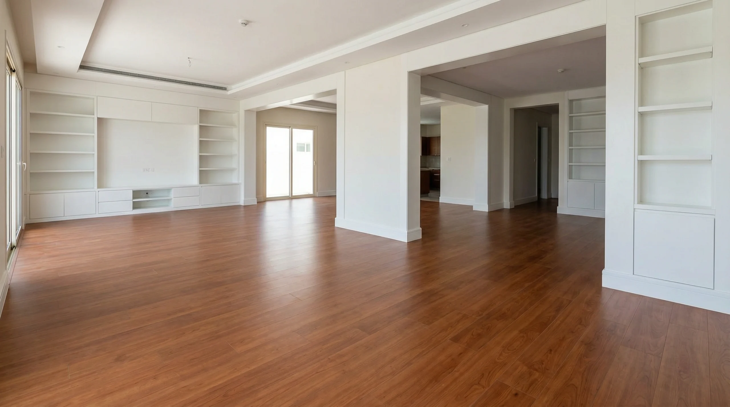 Consistently installed premium cherry wood laminate flooring throughout a large Mirdif villa near custom joinery.