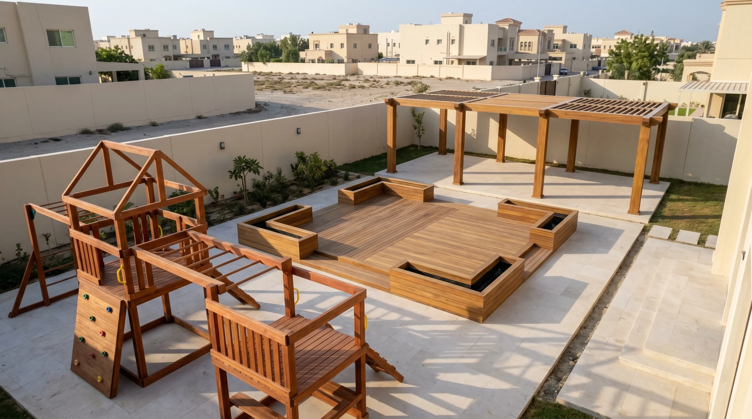 Sharjah family compound with three custom outdoor carpentry structures including pergola, raised deck, and cedar play structure by Karnak Carpentry