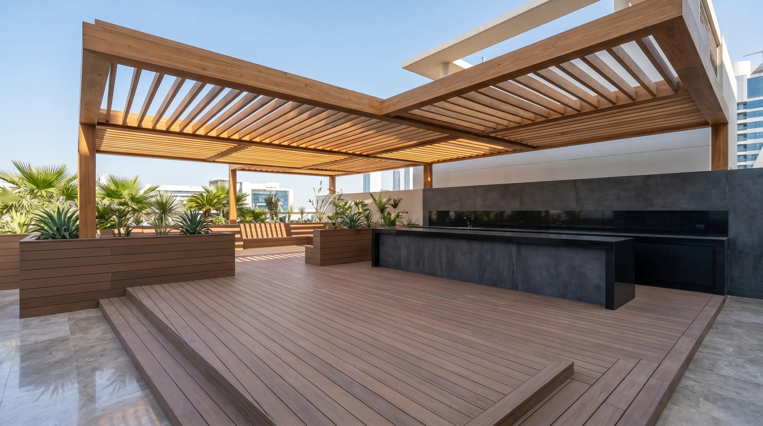 Commercial outdoor dining deck with multi-level composite platform, built-in kitchen counter, and teak canopy at an Abu Dhabi restaurant by Karnak Carpentry