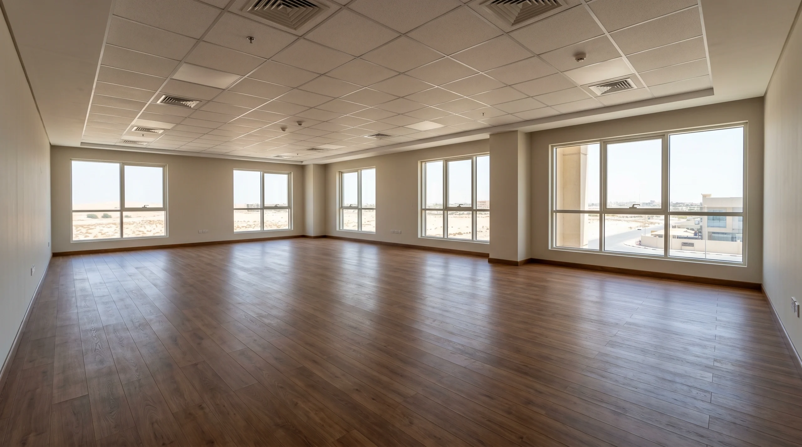 Medium-brown engineered timber flooring installed in Sharjah commercial office space showing Karnak Carpentry's multi-emirate wooden flooring service capability