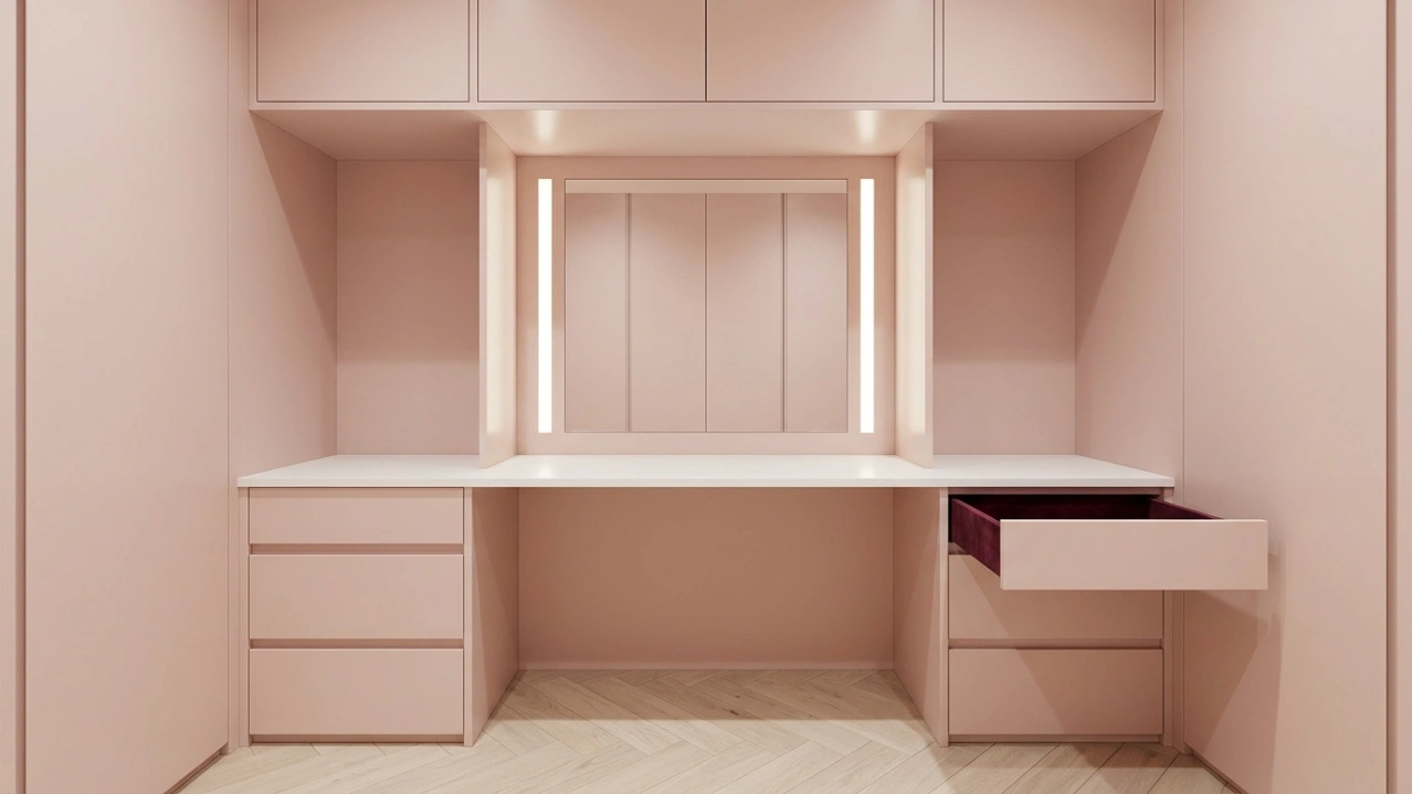 Bespoke makeup vanity in blush pink lacquer with built-in LED mirror frame and velvet-lined drawers in a UAE villa by Karnak Carpentry