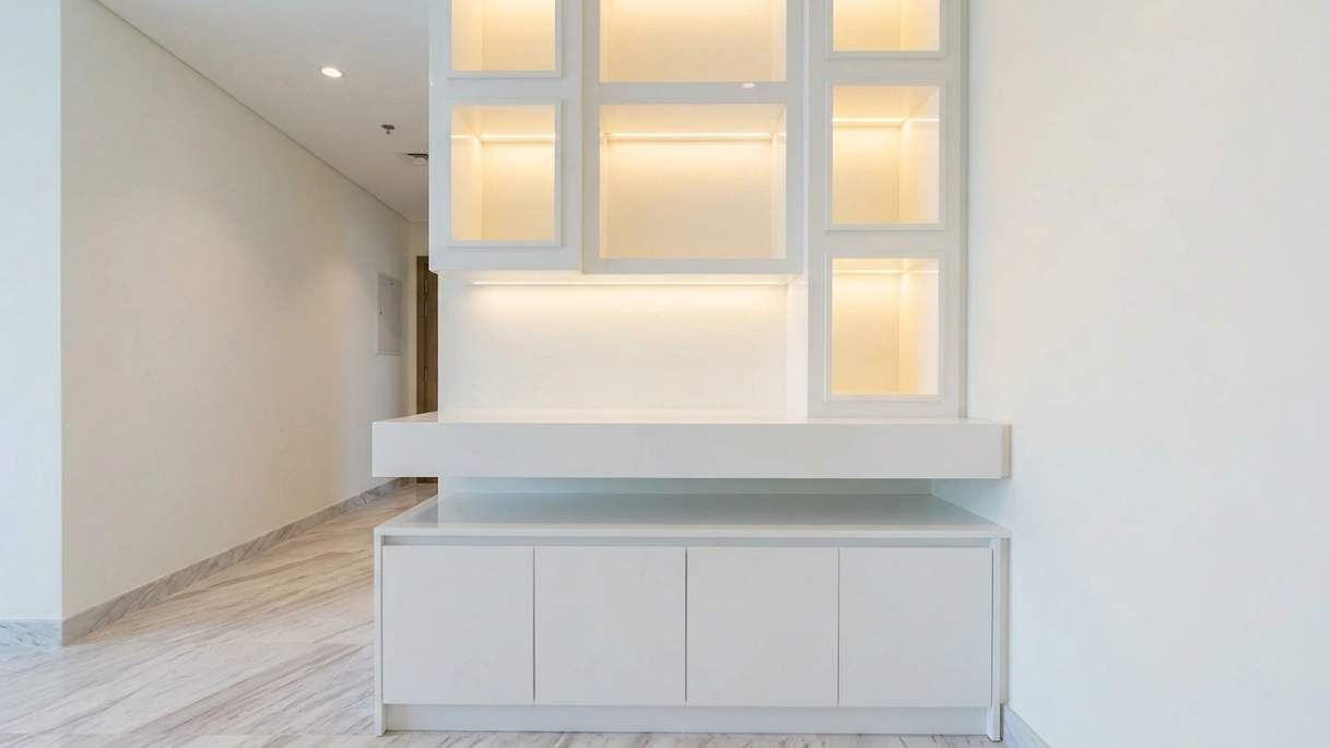 Custom built-in entryway console and display cubby unit in gloss white in Sobha Hartland Dubai apartment entrance