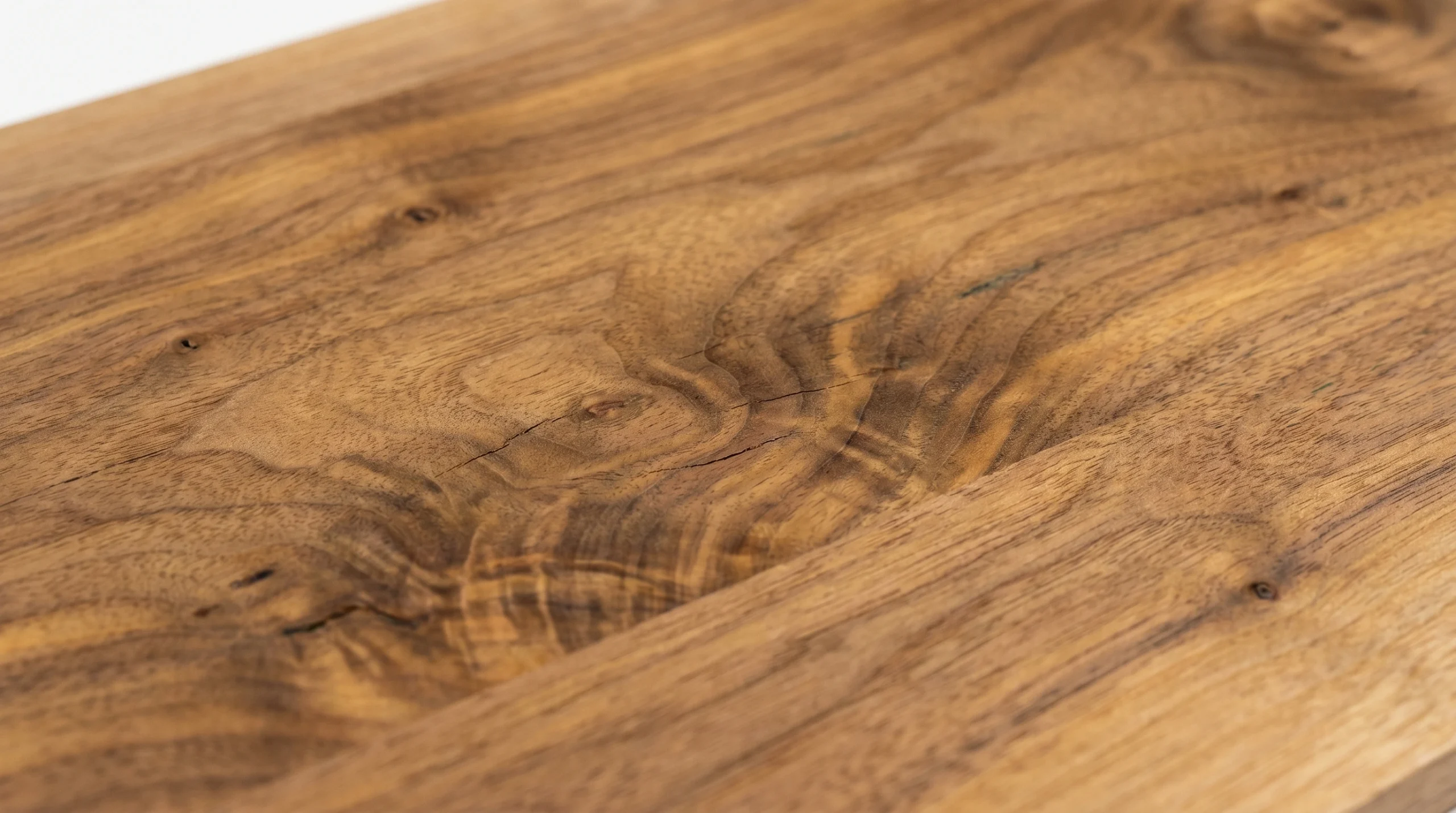 Close-up of walnut veneer grain showing natural wood texture for Dubai interior joinery